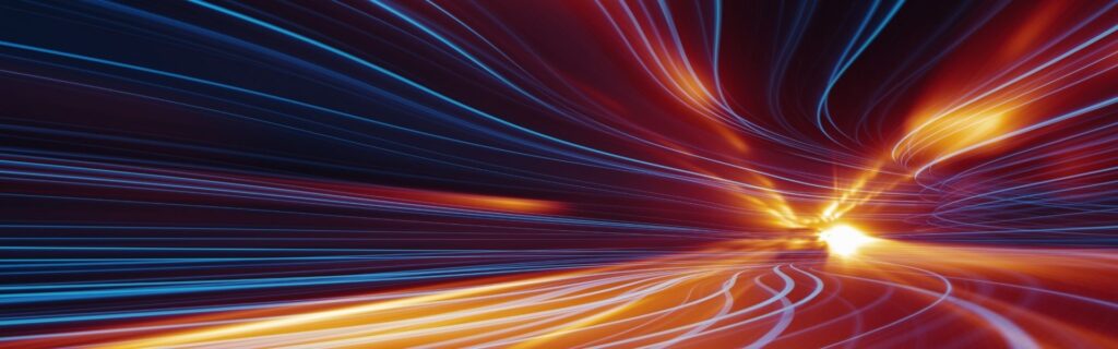 Alt: Langzeitbelichtung einer kurvigen Straße mit blauen und orangefarbenen Lichtspuren bei Nacht; symbolisiert den Ausblick 2026 für Firmenwagen-Besteuerung in Österreich mit möglichen Anpassungen beim Sachbezug, strengeren CO₂‑Grenzwerten und der weiteren Verlagerung zu E‑Autos.